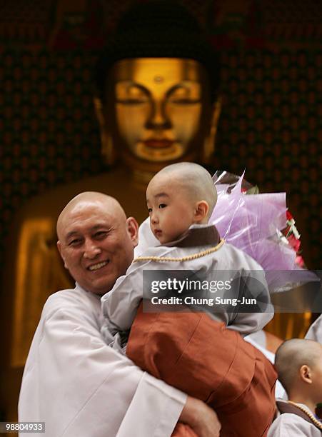 Child carry flower during the 'Children Becoming Buddhist Monks' ceremony forthcoming buddha's birthday at a Chogye temple on May 3, 2010 in Seoul,...