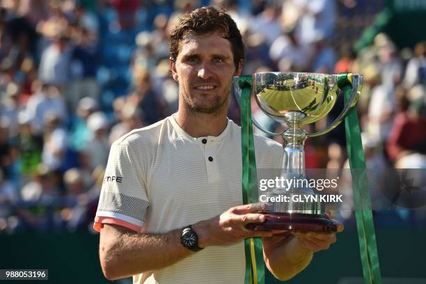 Germany's Mischa Zverev poses with the trophy after his victory over Slovakia's Lukas Lacko in the men's singles finals match at the ATP Nature...