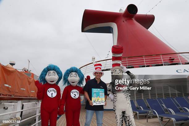 Los Angeles Dodgers player Kike Hernandez poses aboard the Carnival Inspiration before reading Dr. Seuss What Pet Should I Get to children from...