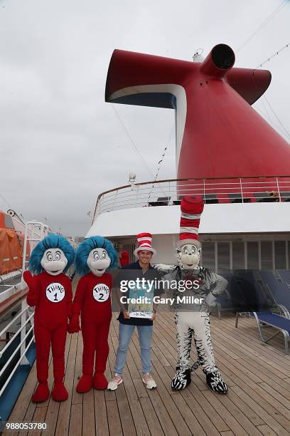 Los Angeles Dodgers player Kike Hernandez poses aboard the Carnival Inspiration before reading Dr. Seuss What Pet Should I Get to children from...