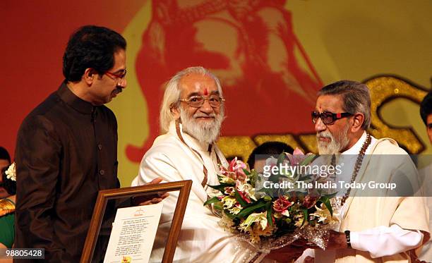 Shiv Sena chief Bal Thackeray and executive president Uddhav Thackeray honour historian Babasheb Purandare during Maharashtra Day celebration at...
