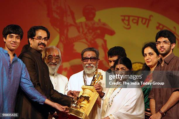 Shiv Sena chief Bal Thackeray honours legendary singer Lata Mangeshkar with his son Uddhav Thackeray, daughter-in-law Rashmi Thackeray and grandson...