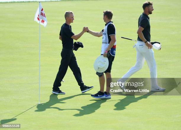 Marcus Kinhult of Sweden celebrates with his caddie on the 18th green after finishing his third round of the HNA Open de France at Le Golf National...