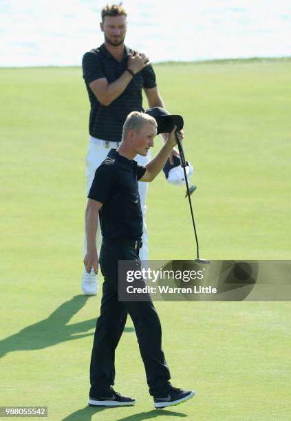 Marcus Kinhult of Sweden celebrates with his caddie on the 18th green after finishing his third round of the HNA Open de France at Le Golf National...