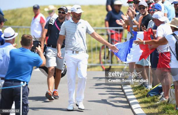Gregory Havret of France walks to the 1st tee past some of his fans during Day Three of the HNA Open de France at Le Golf National on June 30, 2018...