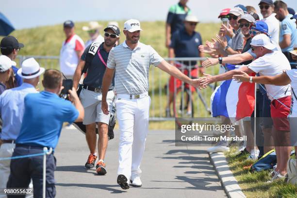 Gregory Havret of France walks to the 1st tee past some of his fans during Day Three of the HNA Open de France at Le Golf National on June 30, 2018...