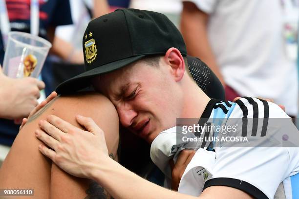Argentina fans react to their team's defeat after the Russia 2018 World Cup round of 16 football match between France and Argentina at the Kazan...