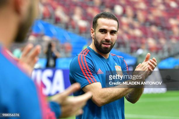 Spain's defender Dani Carvajal applauds as he takes part in a training session of the Spain's national football team at the Luzhniki Stadium in...