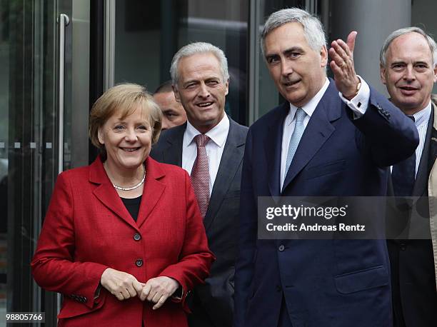 German Chancellor Angela Merkel and German Transport Minister Peter Ramsauer listen as Peter Loescher, CEO of SIEMENS gestures upon their arrival for...