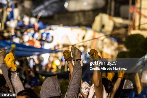 Rescuers, volunteers and firefighters gesture after the magnitude 7.1 earthquake that jolted central Mexico damaging buildings, knocking out power...