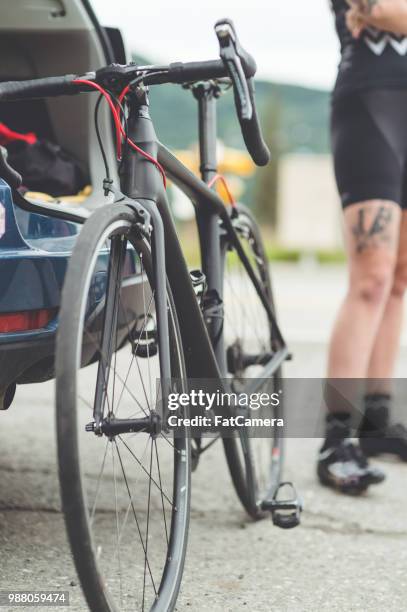 a cyclist gets her bike out of her car - south central alaska stock pictures, royalty-free photos & images