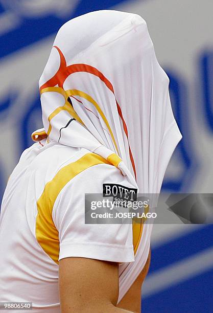 David Ferrer of Spain puts his jersey over his head during a semifinal against Fernando Gonzalez of Chile at the Barcelona Open tennis tournament on...