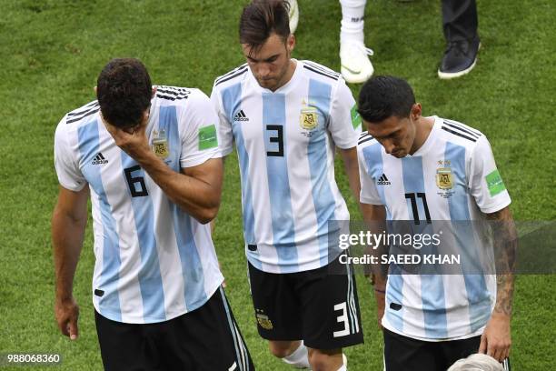 Argentina's defender Federico Fazio, Argentina's defender Nicolas Tagliafico, Argentina's forward Angel Di Maria react after losing the Russia 2018...