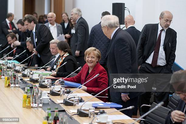 German Chancellor Angela Merkel and German Economy Minister Rainer Bruederle chat prior to the German summit on electric mobility at the...