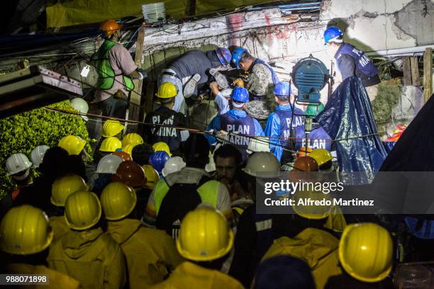 Rescuers, volunteers and firefighters work after the magnitude 7.1 earthquake that jolted central Mexico damaging buildings, knocking out power and...