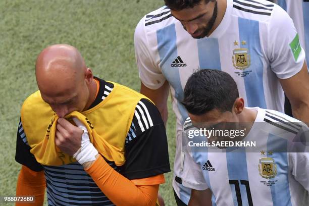 Argentina's goalkeeper Willy Caballero and Argentina's forward Angel Di Maria react after losing the Russia 2018 World Cup round of 16 football match...