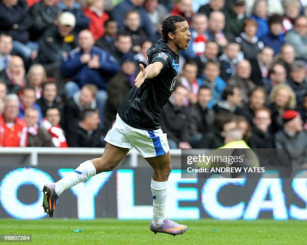 Manchester United's Portugese midfielder Nani celebrates after scoring the opening goal during the English Premiership football match at the Stadium...