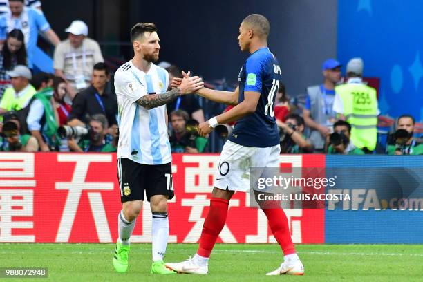 Argentina's forward Lionel Messi congratulates France's forward Kylian Mbappe at the end of the Russia 2018 World Cup round of 16 football match...