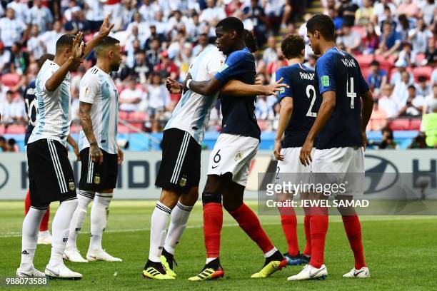 Argentina's defender Federico Fazio vies for the header with France's midfielder Paul Pogba during the Russia 2018 World Cup round of 16 football...