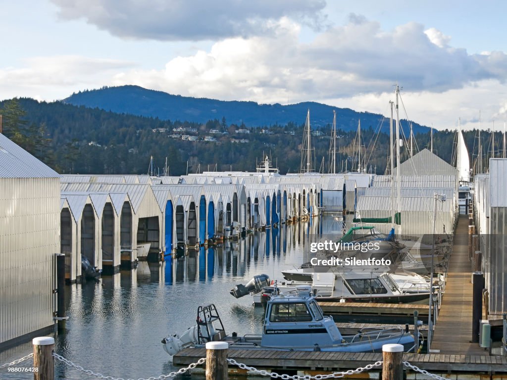 Rows of Boats & Steel Boathouses With Background Landscape, Vancouver Island, BC