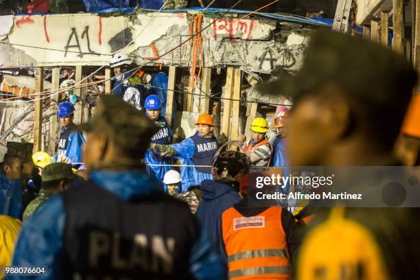 Rescuers, volunteers and firefighters work after the magnitude 7.1 earthquake that jolted central Mexico damaging buildings, knocking out power and...