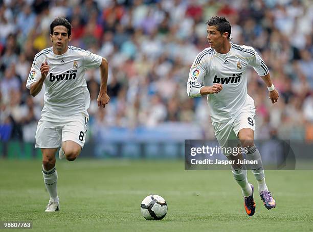 Cristiano Ronaldo of Real Madrid runs with the ball flanked by his teammate Kaka during the La Liga match between Real Madrid and Osasuna at the...