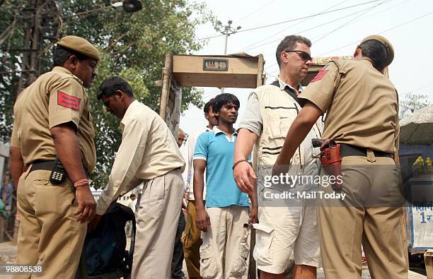 Policemen check people at the Paharganj market in New Delhi on May 2, 2010. The capital remained on high alert for the second successive day...