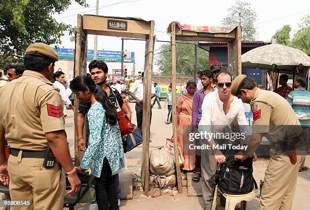 Policemen check people at the Paharganj market in New Delhi on May 2, 2010. The capital remained on high alert for the second successive day...