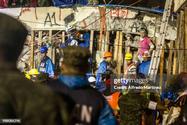 Rescuers, volunteers and firefighters work after the magnitude 7.1 earthquake that jolted central Mexico damaging buildings, knocking out power and...