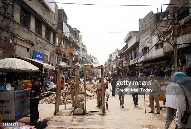 Policemen check people at the Paharganj market in New Delhi on May 2, 2010. The capital remained on high alert for the second successive day...