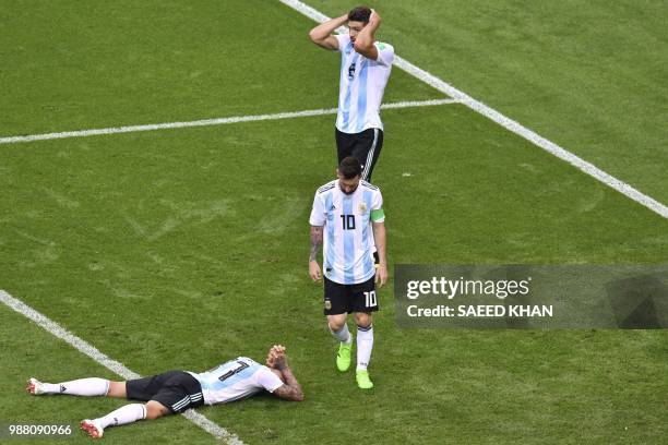 Argentina's defender Nicolas Otamendi , Argentina's forward Lionel Messi and Argentina's defender Federico Fazio react after losing the Russia 2018...