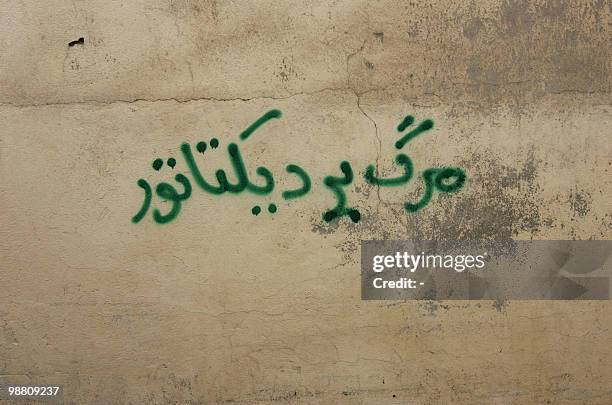 An anti-government graffiti that reads in Farsi "Death to the dictator" is sprayed at a wall north of Tehran on September 30, 2009. AFP PHOTO/STR