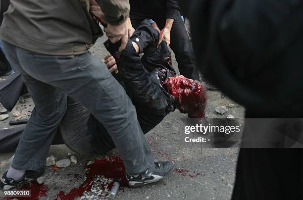 Iranian protesters carry the body of a man who was allegedly shot during an anti-government protest in Tehran on December 27, 2009. Security forces...