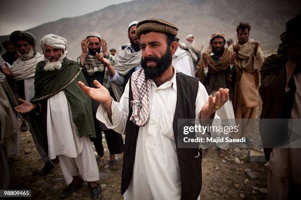 Afghan tribesmen from the Pashtun ethnic minority pray in an area south of Kabul on May 2, 2010 in Afghanistan. This migratory tribe base a large...