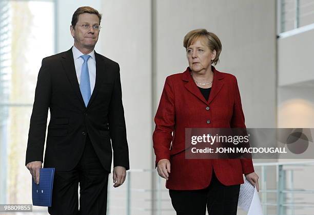 German Chancellor Angela Merkel and German Foreign Minister and vice-chancellor Guido Westerwelle arrive for a press conference following a cabinet...