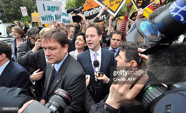 Liberal Democrat leader Nick Clegg walks with his wife Miriam Gonzalez Durantez as he visits the Palace Project community centre in Streatham, South...