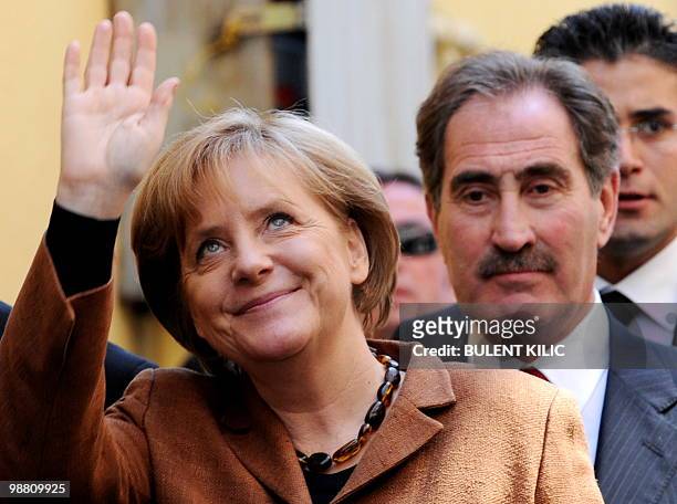 German Chancellor Angela Merkel and Turkish Culture Minister Ertugrul Gunay arrive at the German Evangelist Church in Istanbul on March 30, 2010....