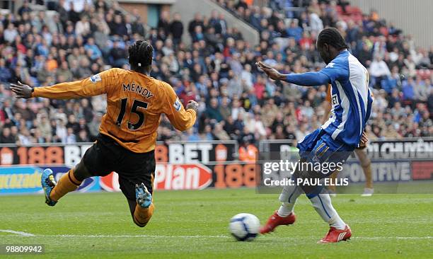 Wigan Athletic's Victor Moses scores against Hull City during their English Premier League football match at The DW Stadium in Wigan, north-west...