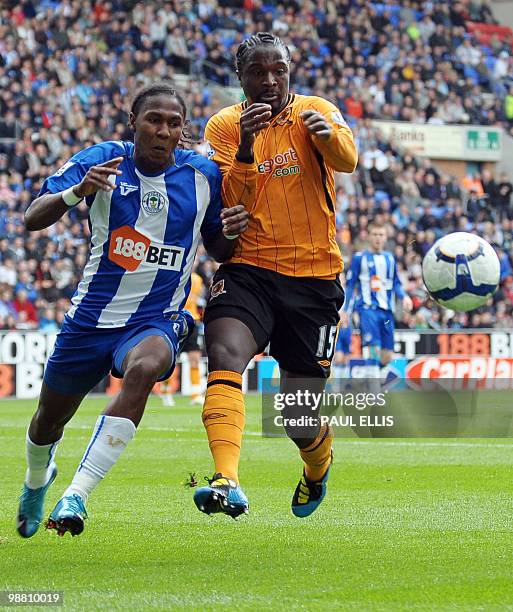 Wigan Athletic's Columbian forward Hugo Rodallega and Hull City's French defender Bernard Mendy compete for the ball during their English Premier...