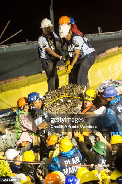 Rescuers, volunteers and firefighters work after the magnitude 7.1 earthquake that jolted central Mexico damaging buildings, knocking out power and...