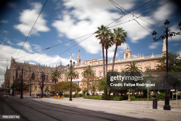 archivo de indias (right) and cathedral (left), seville, spain - de archivo stock pictures, royalty-free photos & images