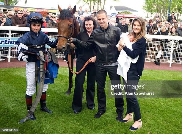 Chelsea and England footballer Joe Cole poses with his wife Carly baby daughter Ruby and jockey Adam Beschizza after his horse Poppanan wins The...