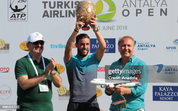 Damir Dzumhur of Bosnia and Herzegovina poses with the trophy after men's single final match against Adrian Mannarino of France during Turkish...