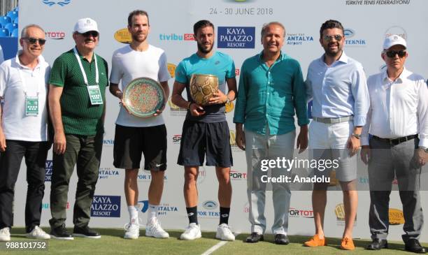 Damir Dzumhur of Bosnia and Herzegovina poses with the trophy after winning against Adrian Mannarino of France in the men's single final match within...