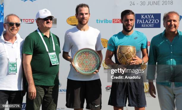 Damir Dzumhur of Bosnia and Herzegovina poses with the trophy after winning against Adrian Mannarino of France in the men's single final match within...