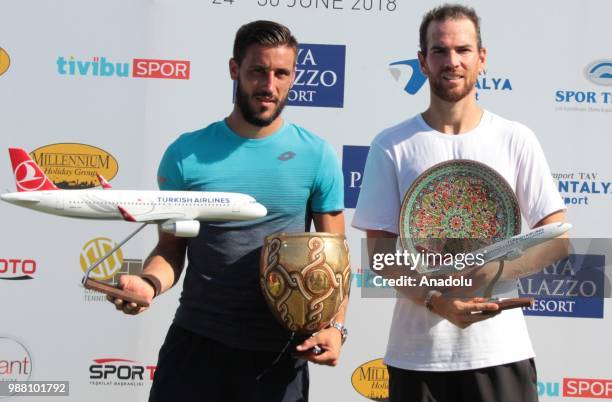 Damir Dzumhur of Bosnia and Herzegovina poses with the trophy after winning against Adrian Mannarino of France in the men's single final match within...