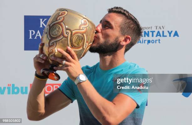 Damir Dzumhur of Bosnia and Herzegovina poses with the trophy after men's single final match against Adrian Mannarino of France during Turkish...