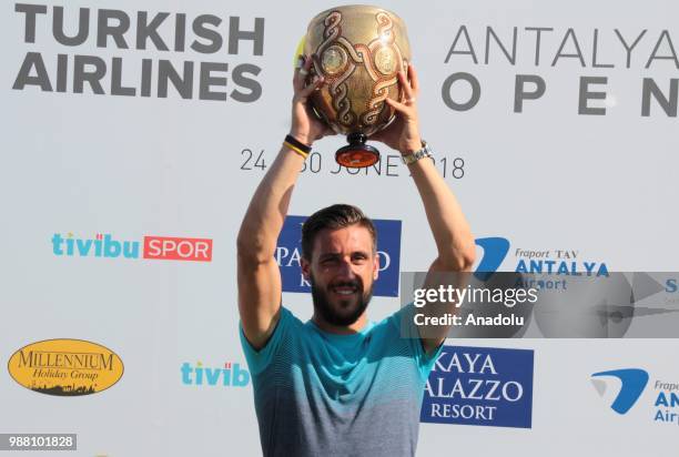 Damir Dzumhur of Bosnia and Herzegovina poses with the trophy after men's single final match against Adrian Mannarino of France during Turkish...