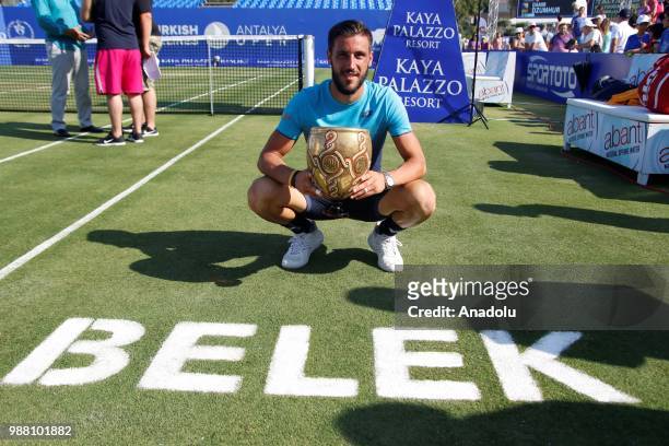 Damir Dzumhur of Bosnia and Herzegovina poses with the trophy after men's single final match against Adrian Mannarino of France during Turkish...