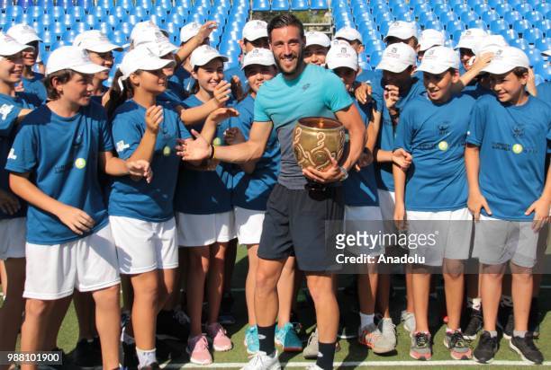 Damir Dzumhur of Bosnia and Herzegovina poses with the trophy after men's single final match against Adrian Mannarino of France during Turkish...